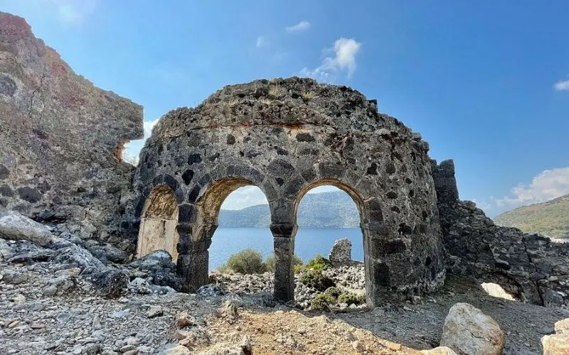 Stone ruins with arched windows overlooking the sea on Gemiler Island.