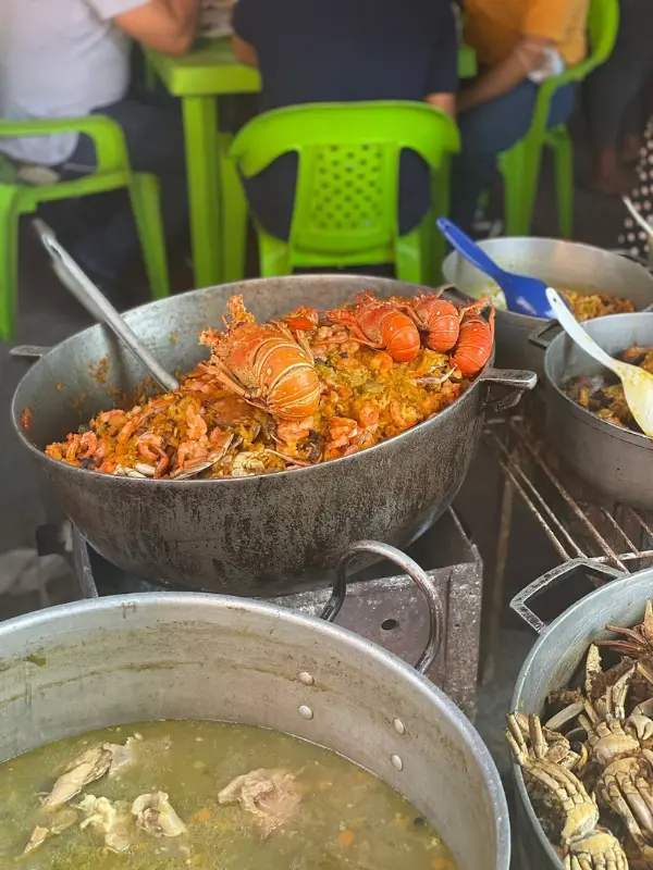 Large pot of seafood rice being served at Mercado de Bazurto.