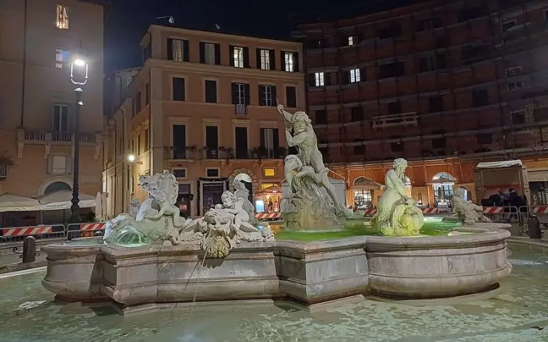 Piazza Navona in Rome, Italy with fountain statues at night.