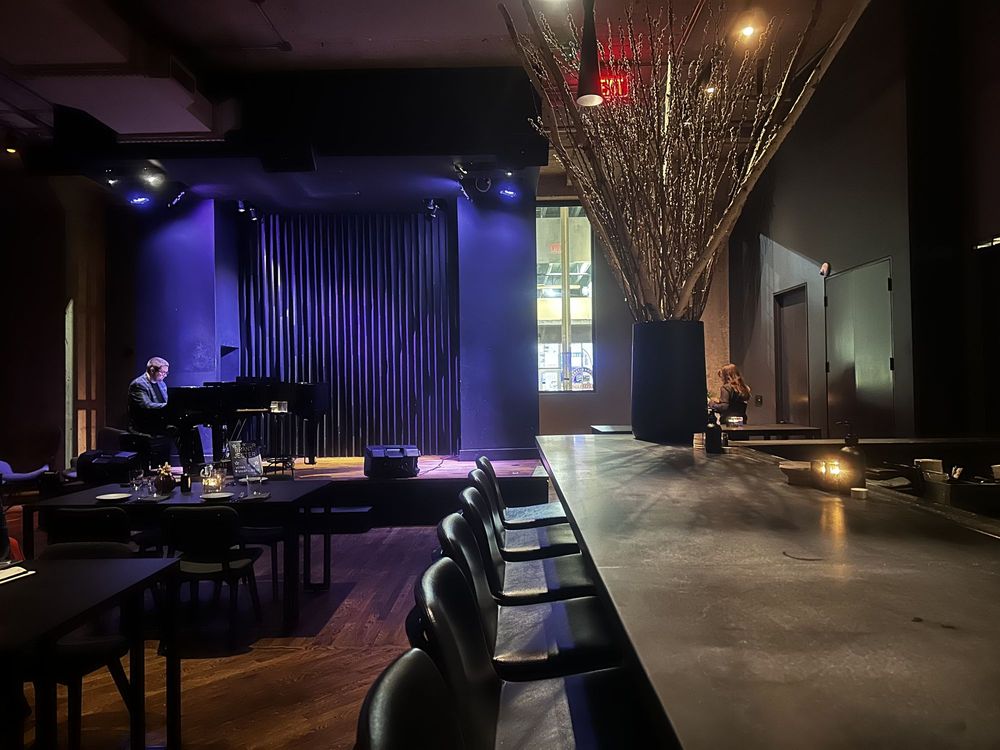 Live piano performance in a stylish, modern dining space at CORVINO.