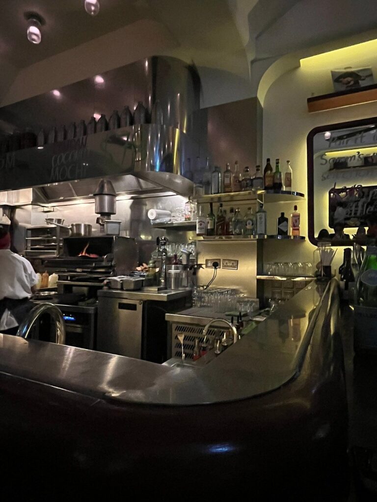 Lively and compact kitchen bar at Chôm Chôm with a cozy, urban vibe.