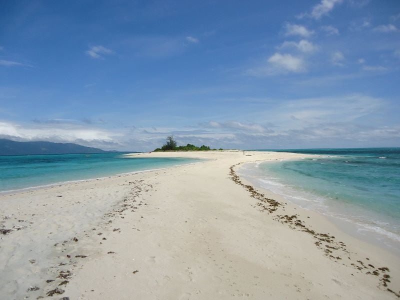 Aerial view of Cresta de Gallo Island's stunning coastline with white sandy beaches and clear blue waters