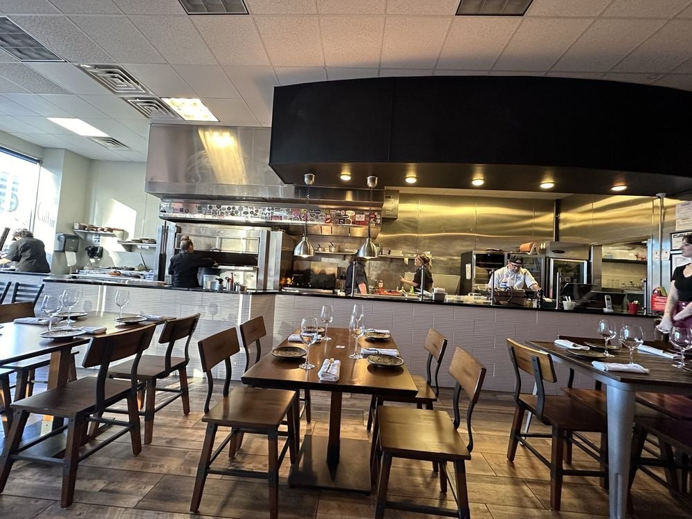 Modern open kitchen and dining area inside Culture ETX restaurant.
