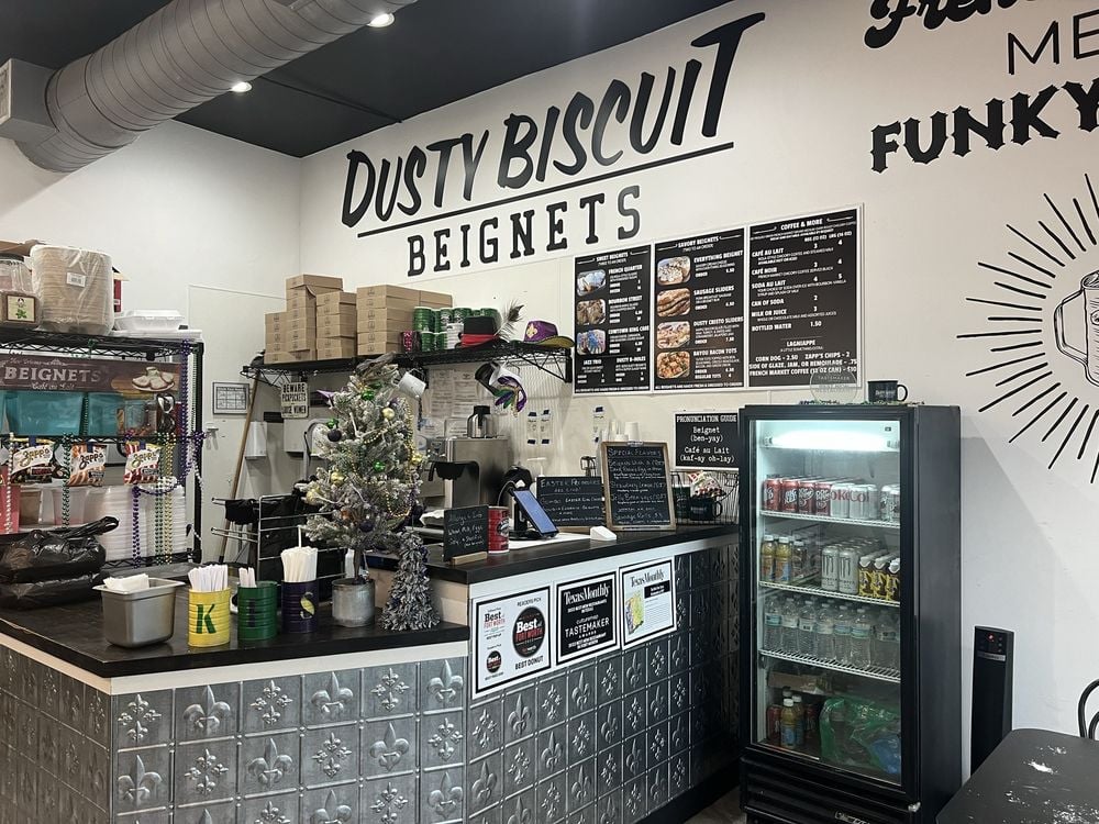 Dusty Biscuit counter area with a menu board, drink cooler, and festive decorations.