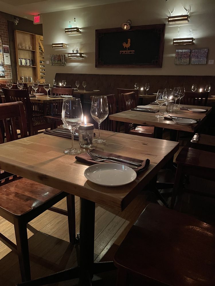 Warm, intimate dining room with candlelit tables at Fable Kitchen.