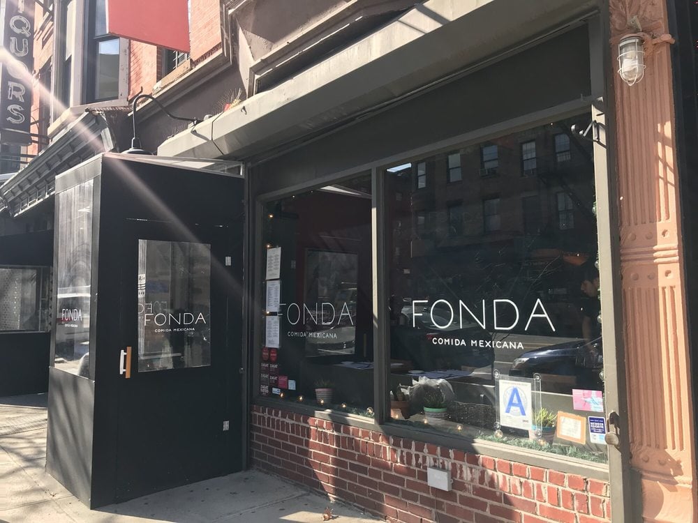 Exterior of Fonda, a Mexican restaurant with sleek black signage.
