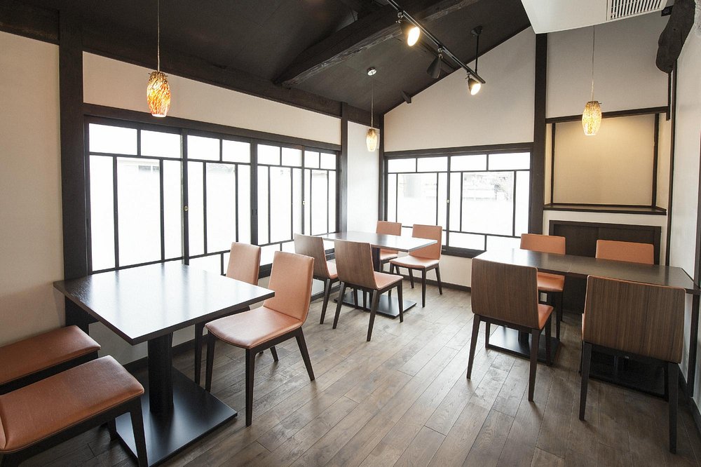 Bright and modern dining room at KISSHOKARYO KYOTO with wooden floors and simple seating.