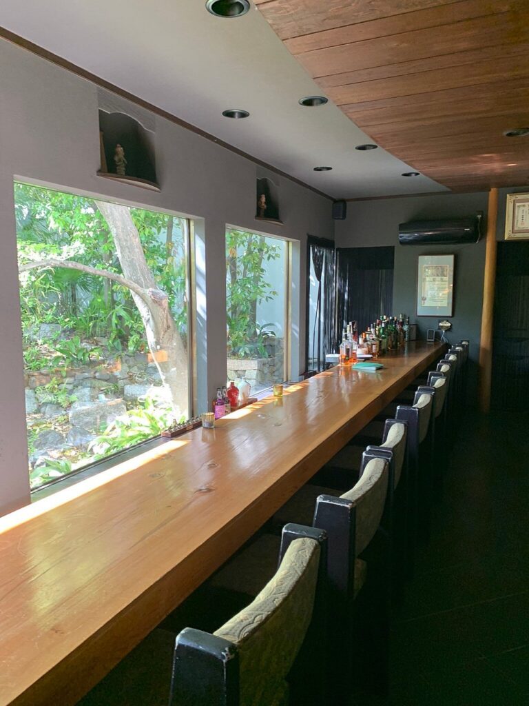 Long wooden bar at Kanga-an Temple with garden views and natural light.