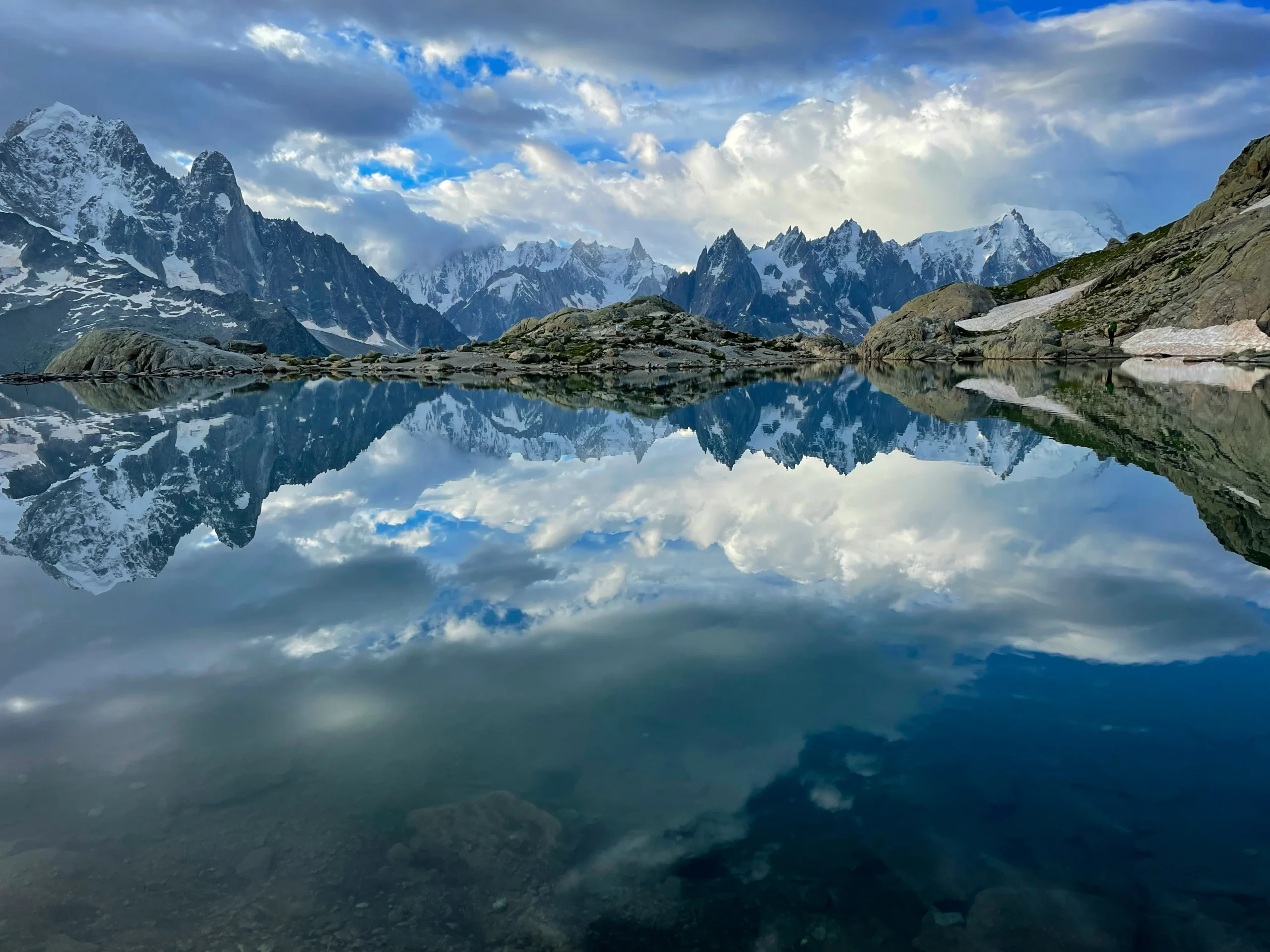 Perfect mirror reflection of snow-capped Mont Blanc mountain range in the still waters of Lac Blanc alpine lake in Chamonix