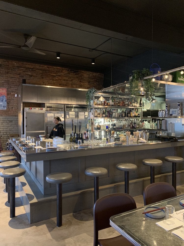 Open kitchen and bar area with modern industrial design at Lunch Lady.