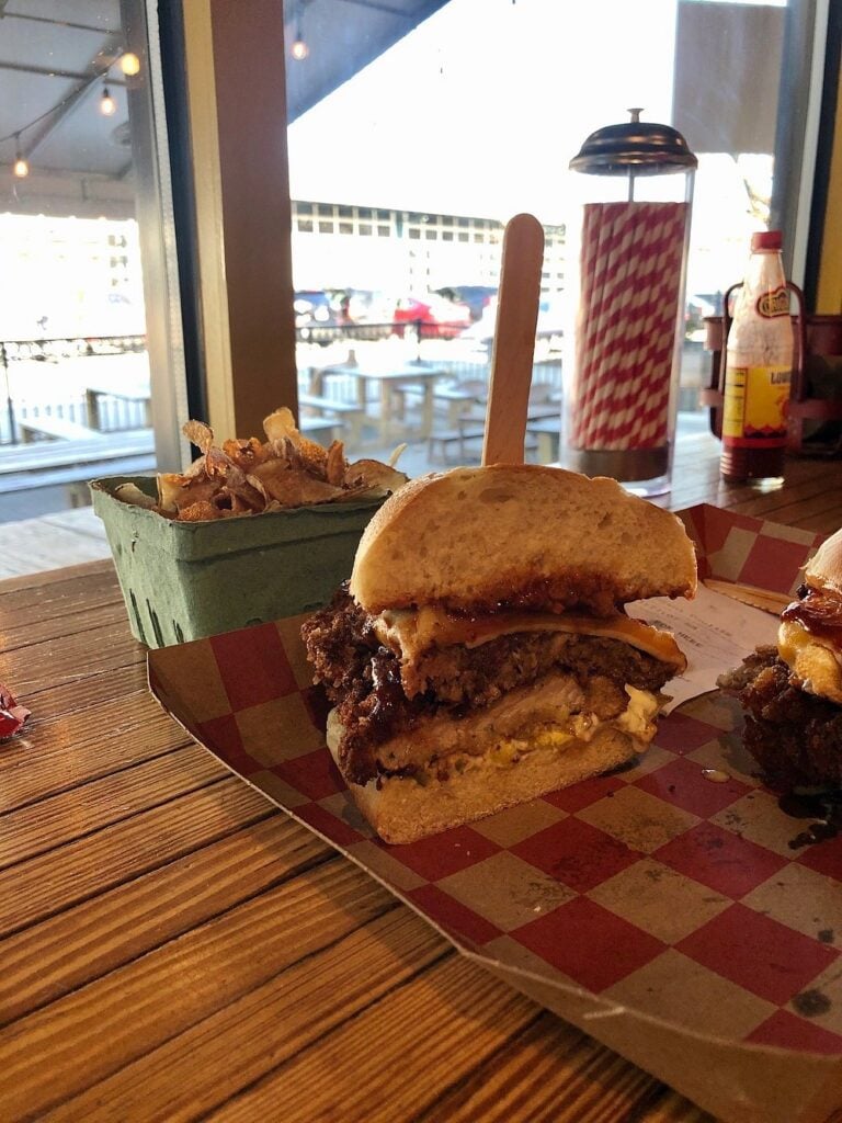 Hearty sandwich with fries by the window at Pigwich.