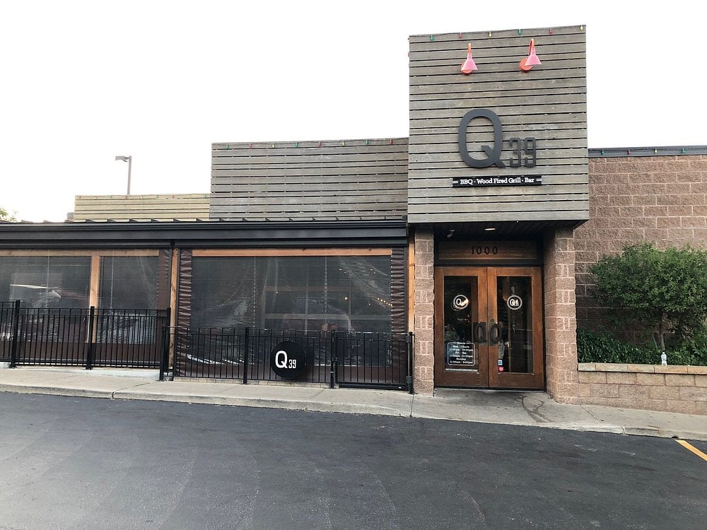 Exterior view of Q39 BBQ restaurant with modern wood-paneled design.