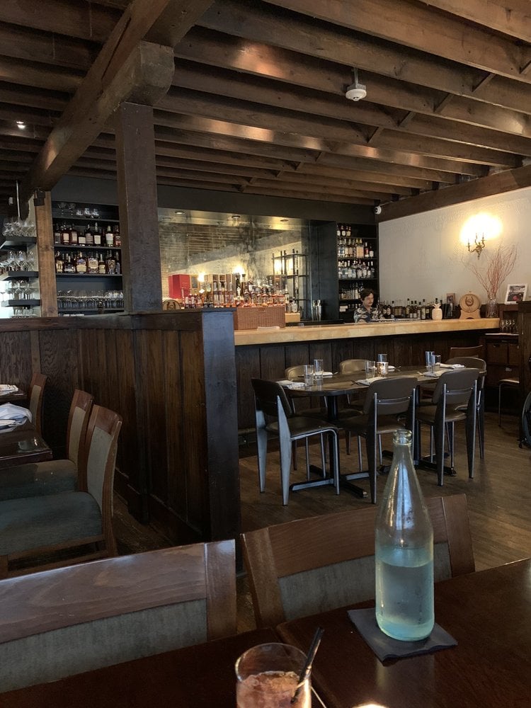 Elegant interior of Restaurant Orsay with a wooden bar and exposed beams.