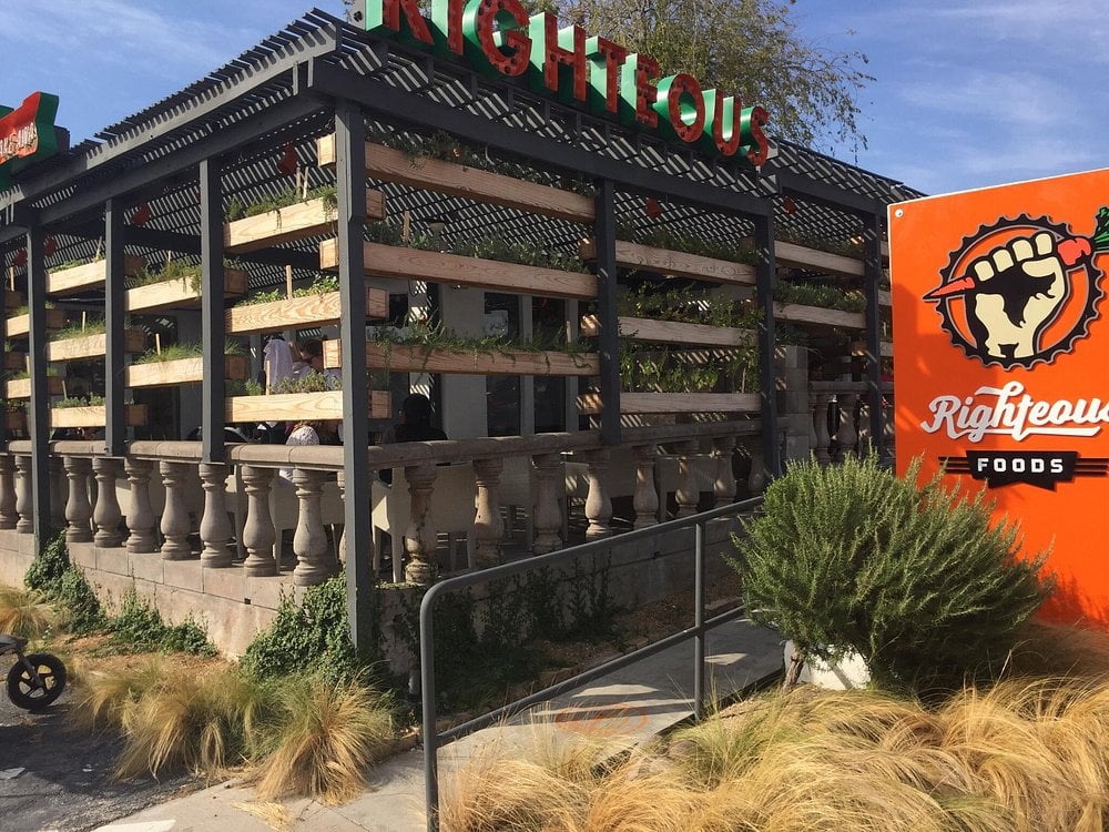 Righteous Foods exterior with a covered patio and bold orange sign.