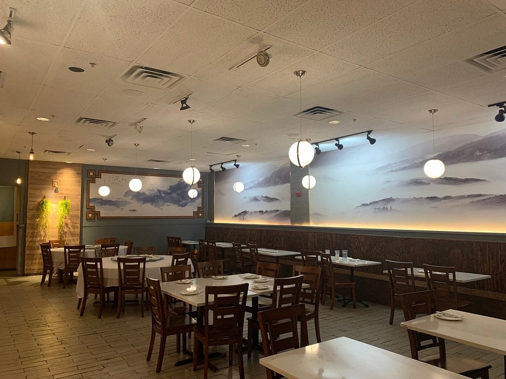 Interior of S & R Dim Sum with hanging lights and misty mountain wall art.