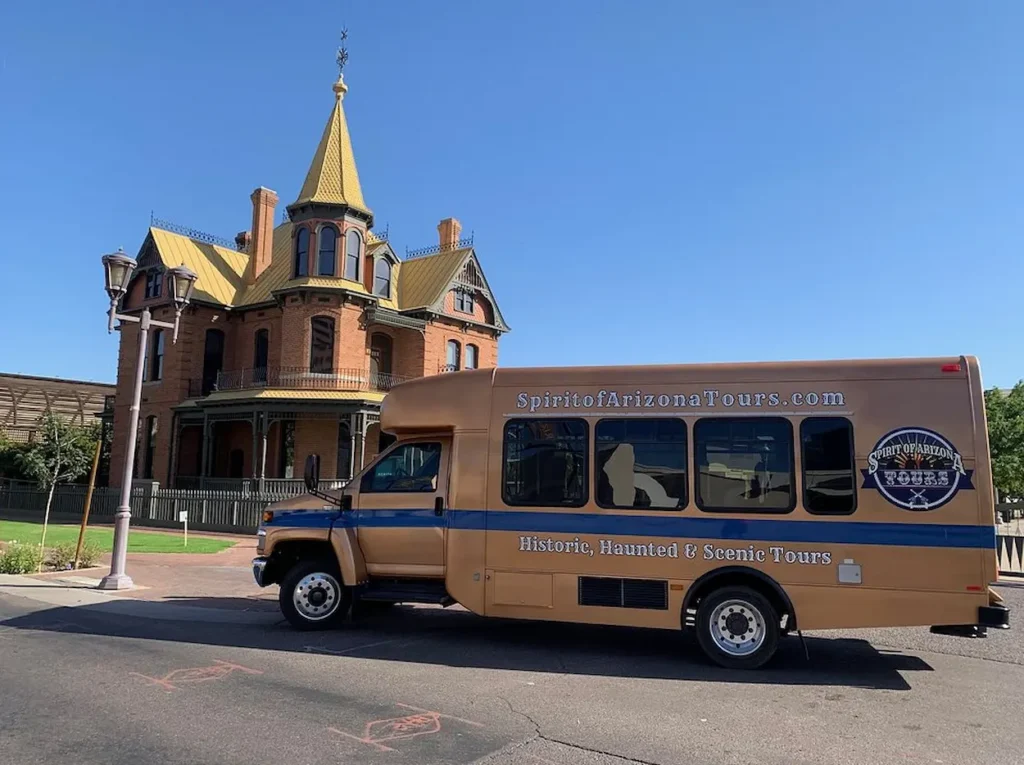 A Spirit of Arizona tour bus parked in front of the Rosson House Museum