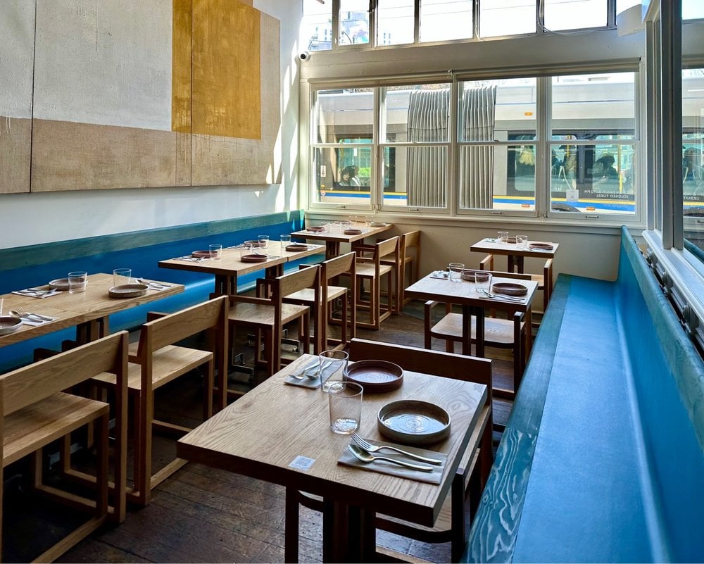 Bright, minimal dining room with natural light and simple decor at Song.