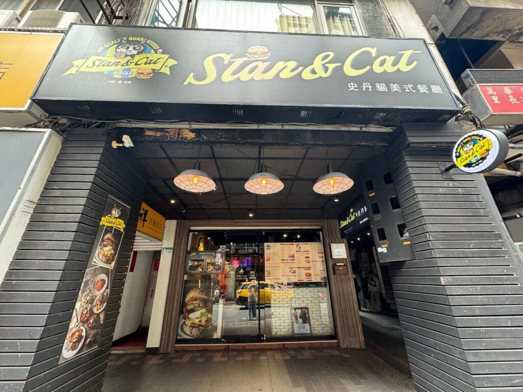 Stan & Cat Burger restaurant entrance with menu and black storefront.