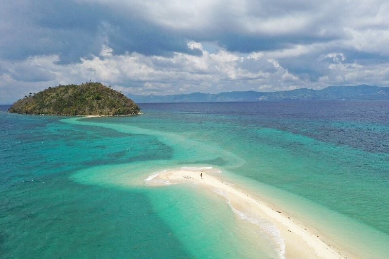 A pristine beach with golden sands and clear blue waters