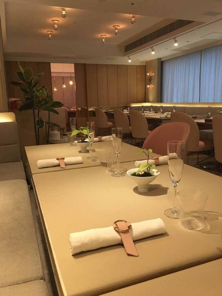Soft, elegant setting at TATE Dining Room with neutral tones and minimal decor.
