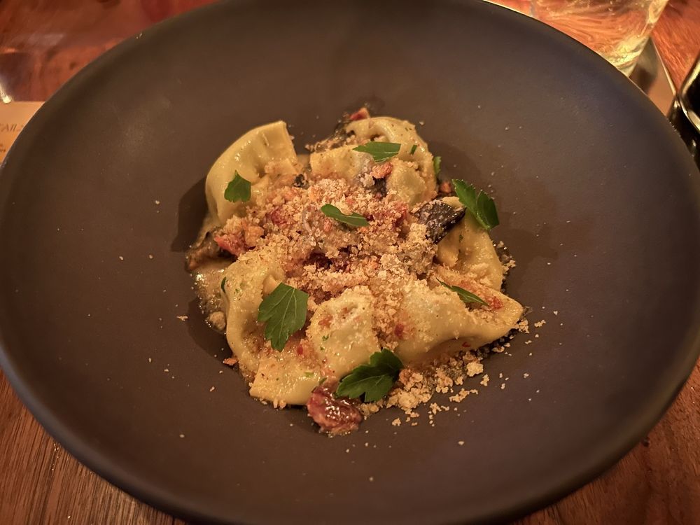 A plated pasta dish garnished with herbs at The Antler Room.