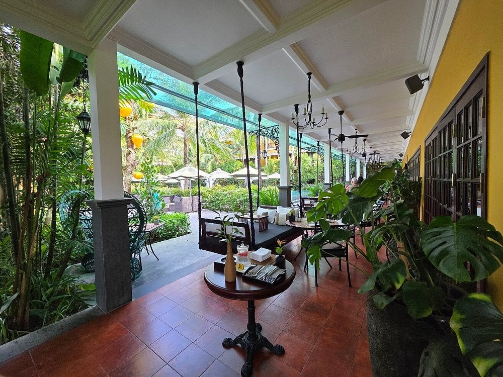 Elegant covered patio at The Temple with garden views and hanging lanterns.