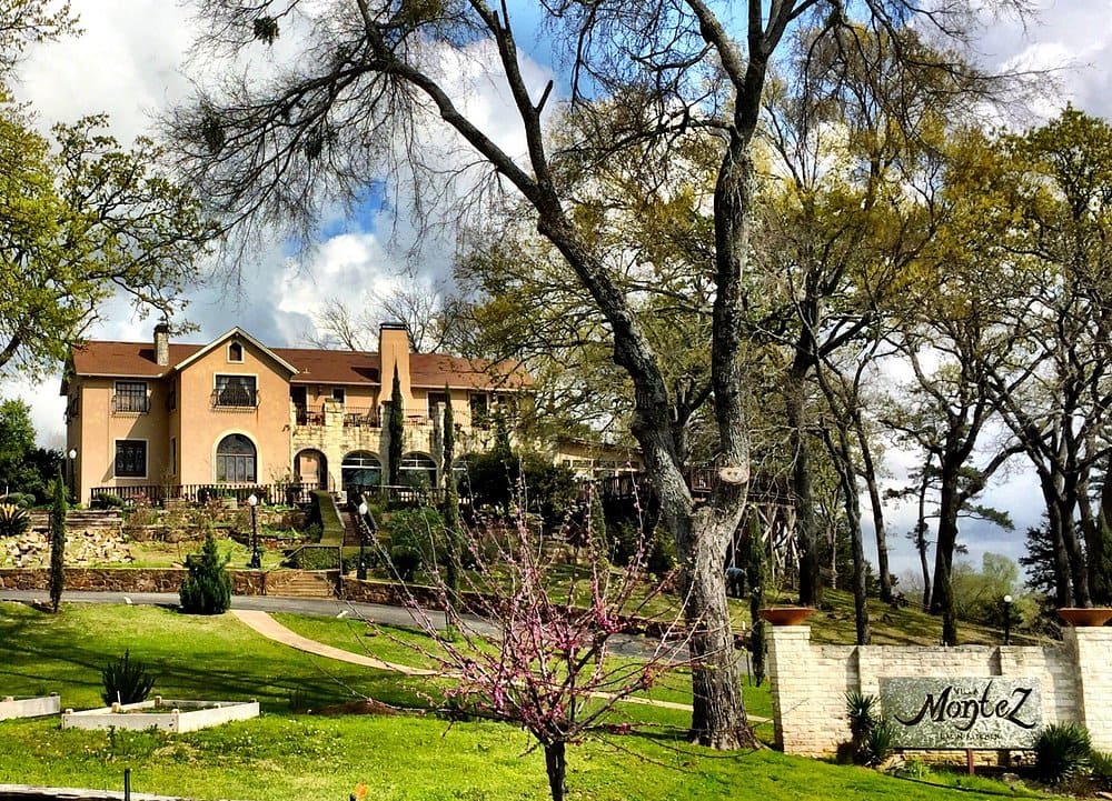 Scenic view of the grand Villa Montez restaurant surrounded by trees.