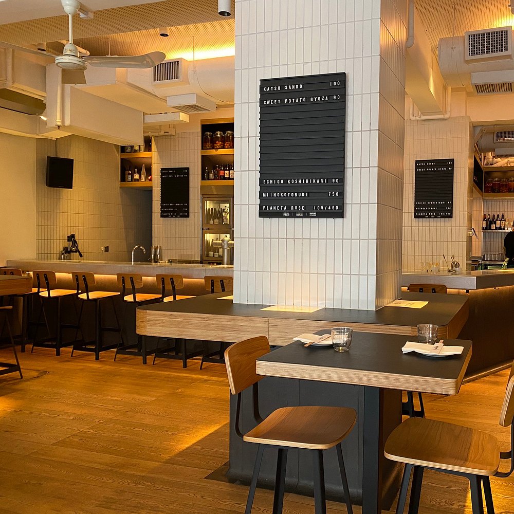 Sleek and modern interior at Yardbird with wood and tile accents.
