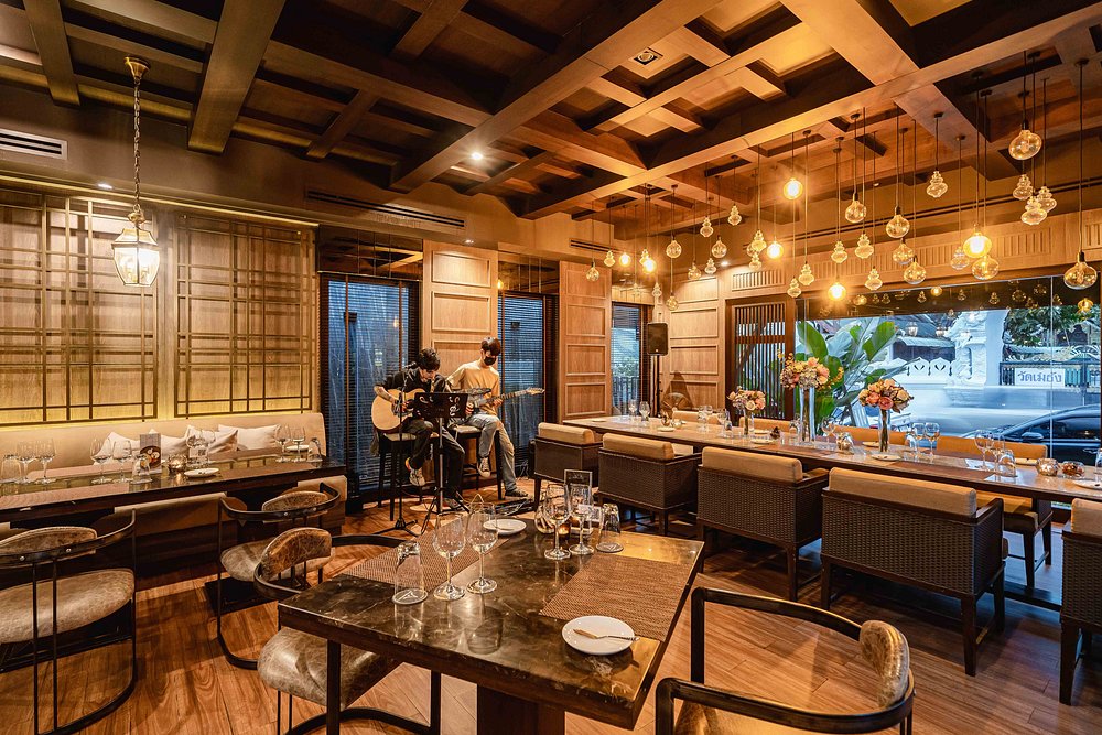 The Vorra Bistro interior with warm lighting, elegant decor, and live acoustic music.