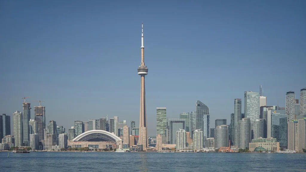 CN Tower and Rogers Centre anchoring the Toronto city skyline across Lake Ontario