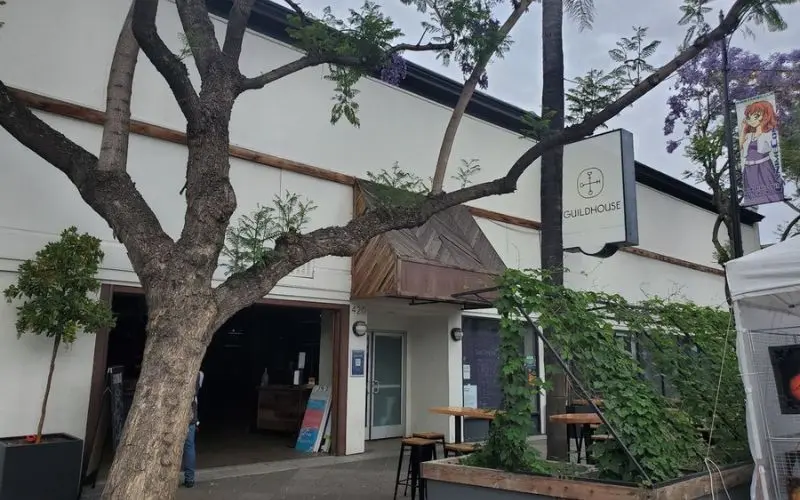 The exterior of Guildhouse with its modern entrance and greenery.