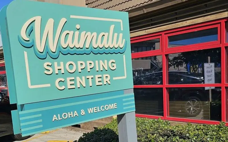 A teal sign for Waimalu Shopping Center.