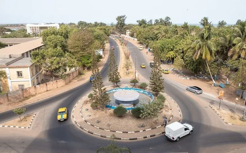 Banjul in Gambia with roundabout, palm trees, and city streets.