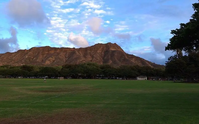 Wide grassy field with Diamond Head in the background at Kapiolani Park.