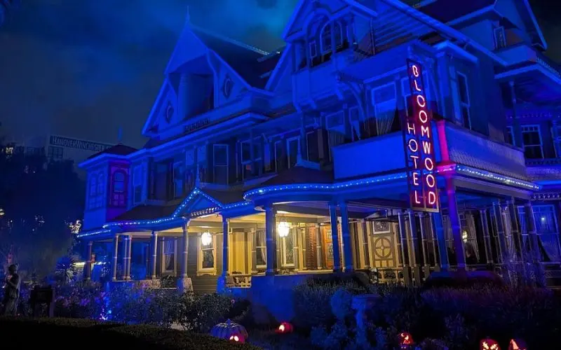 The Winchester Mystery House is lit up with blue lights at night.
