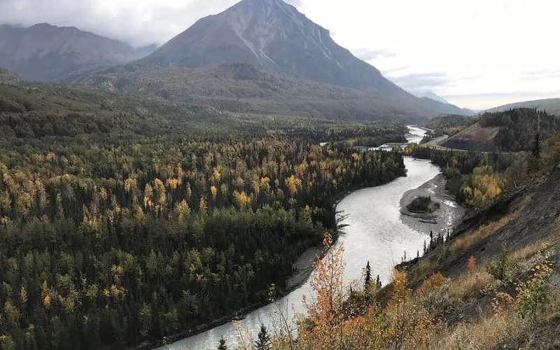 Winding river through forested valley with mountains at Gateway.