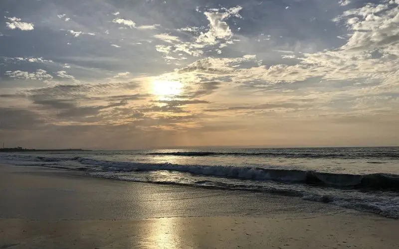 Brufut Beach in Gambia with waves at sunset.