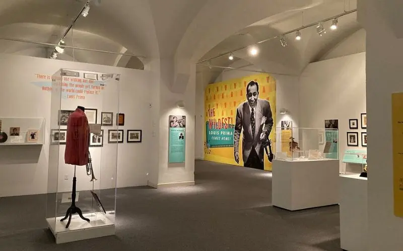 New Orleans Jazz Museum with exhibits, photos, and a large mural inside a gallery.