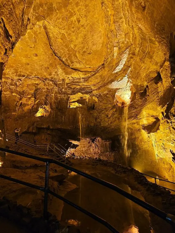 Underground rock formations and waterfalls inside Dan yr Ogof Caves.