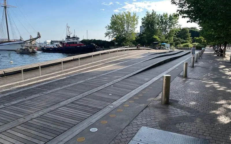 Wooden boardwalk and boats along the waterfront in Toronto.