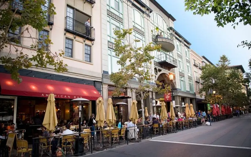 Diners sit outside restaurants along Santana Row.