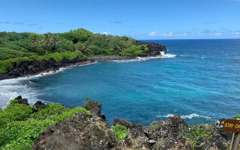 Waves hitting the black sand beach and cliffs in Lahaina.