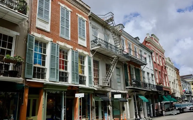 Royal Street with rows of shuttered buildings and wrought iron balconies.