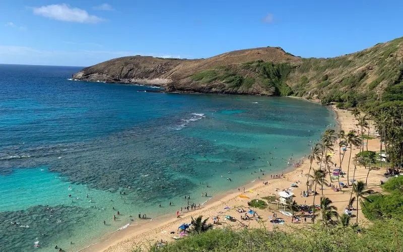People swimming and relaxing at Hanauma Bay in Oahu.