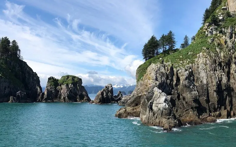 Rocky cliffs and blue water along the coast in Seward.