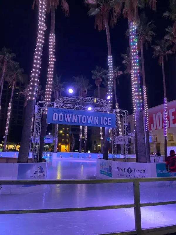 The Kristi Yamaguchi Downtown Ice skating rink glowing with lights at night.