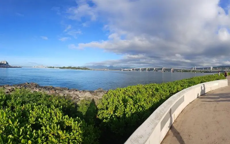 A waterfront view with a bridge and boats in Pearl City.