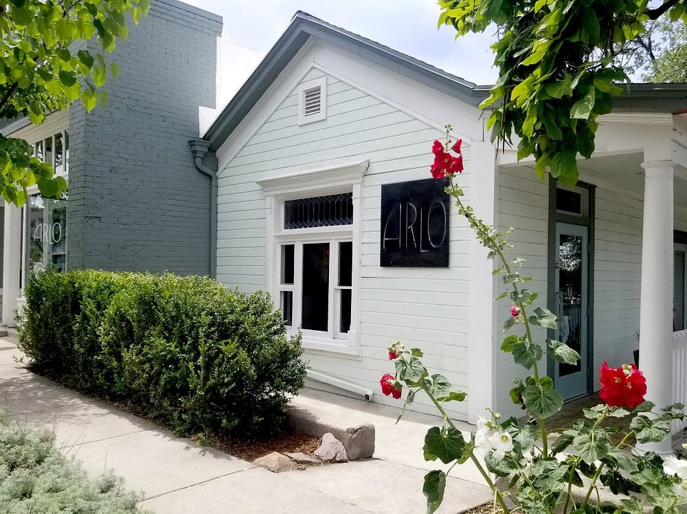 Exterior view of Arlo, a charming white house-style restaurant.