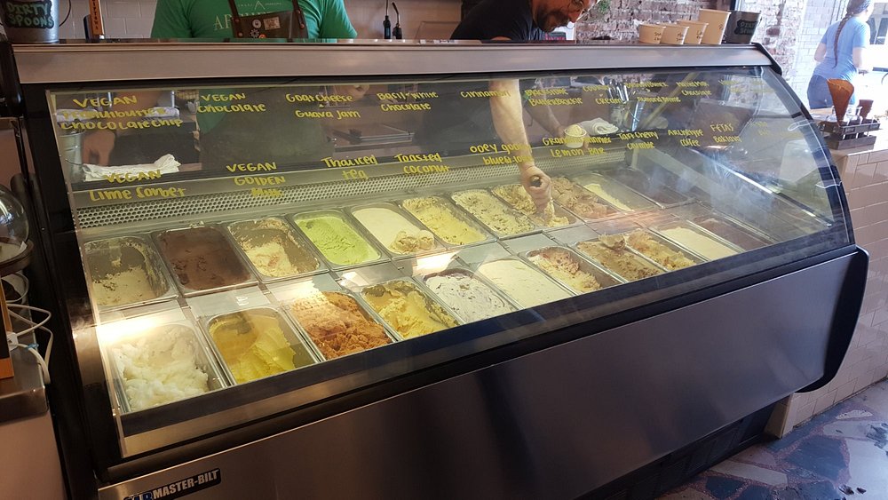Ice cream counter featuring a wide variety of unique flavors at Coneflower Creamery.