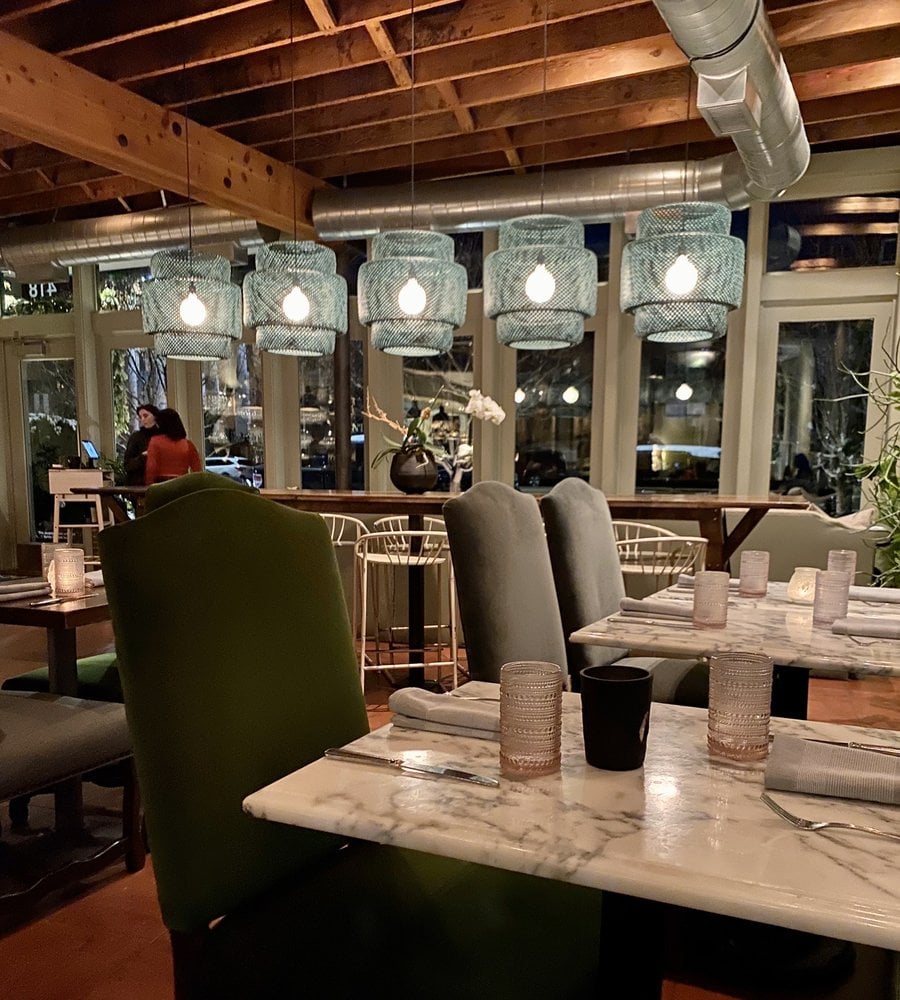 Chic, intimate dining room with marble tables and soft lighting at HSL.